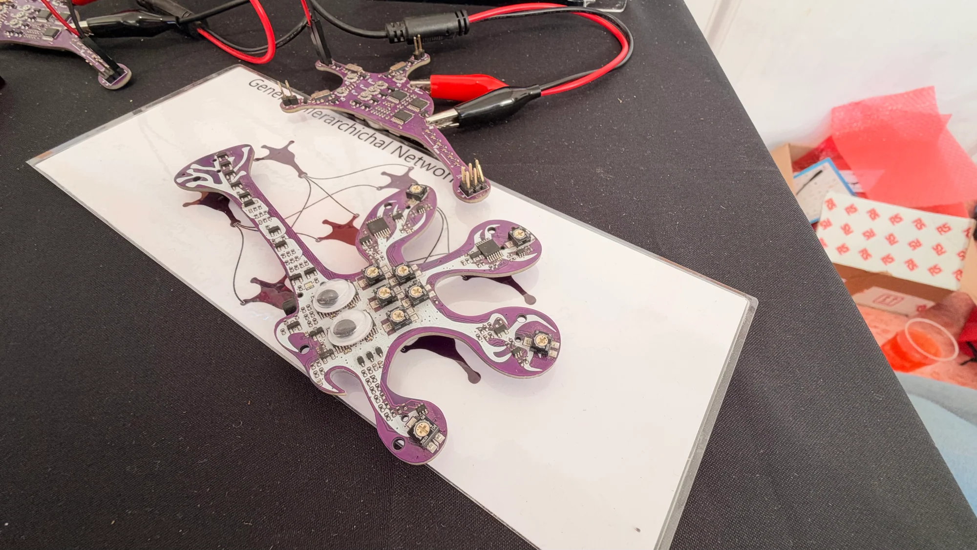 Neuron-shaped purple circuit boards with electronic components and test connections
