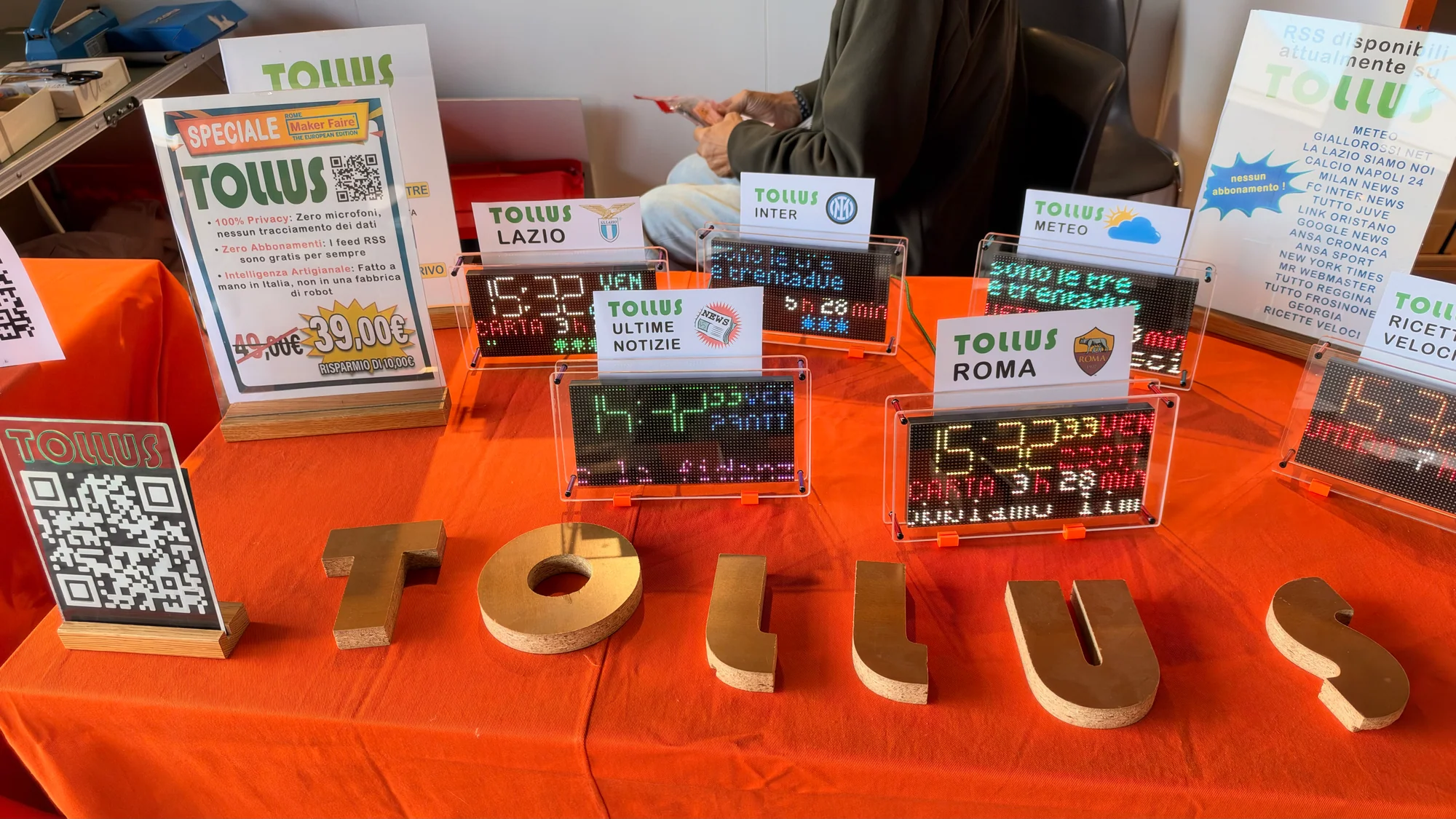 Tollus illuminated clock and information displays arranged on an exhibition table
