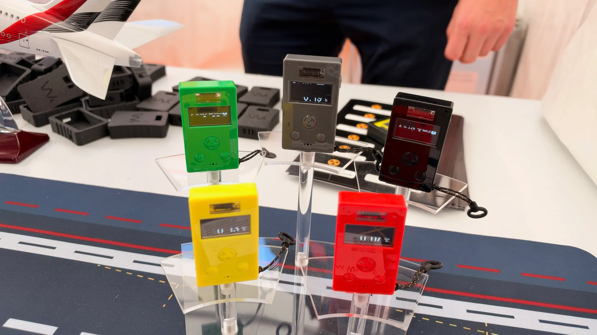 Compact DOZE Geiger counters displayed in several colored enclosures